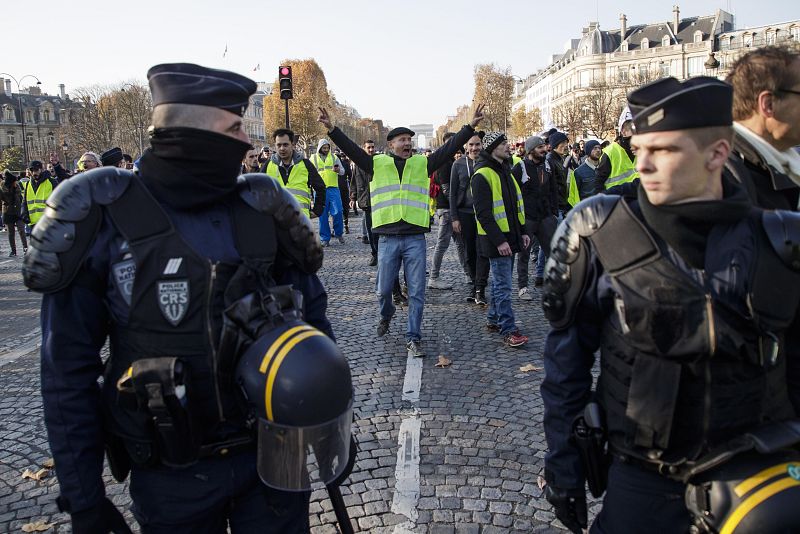 La policía escolta una marcha en los Campos Elíseos en París