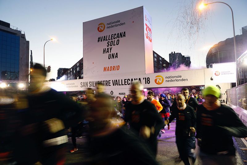 Numerosos corredores tras tomar la salida de la San Silvestre Vallecana Popular, la emblemática carrera del final del año en Madrid.