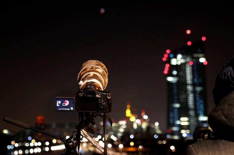 Un fotógrafo captura instantáneas del evento astronómico cerca de las oficinas del Banco Central Europeo, en Frankfurt (Alemania).