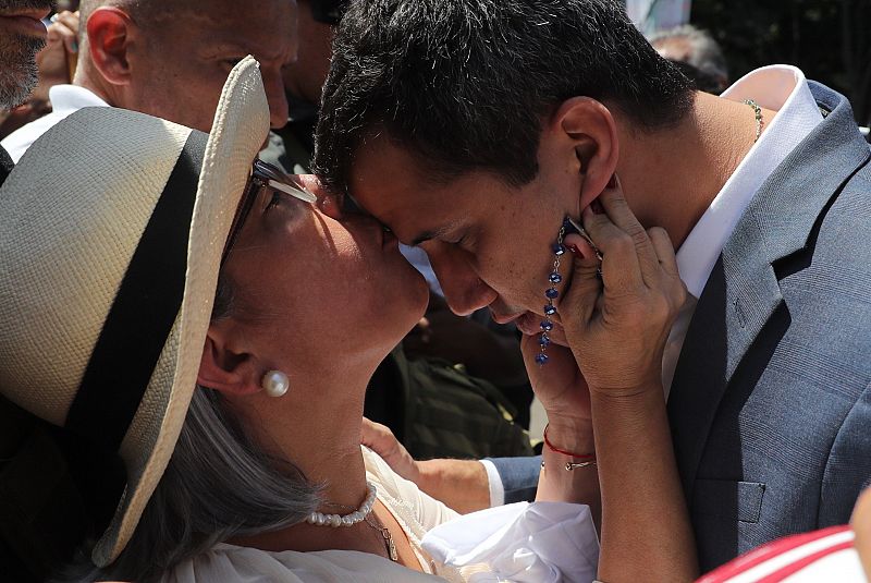 El presidente de la Asamblea Nacional de Venezuela, Juan Guaidó, recibe un beso de su madre, Norka Márquez, antes de hablar ante los asistentes a una manifestación en su apoyo y en contra del presidente de Venezuela, Nicolás Maduro