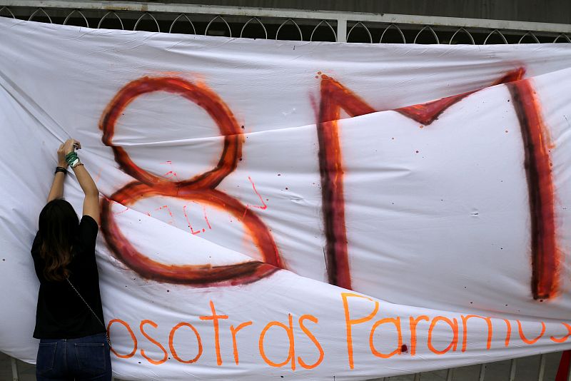 Student arranges a banner outside the National Autonomous University of Honduras during a strike to mark International Women's Day in Tegucigalpa