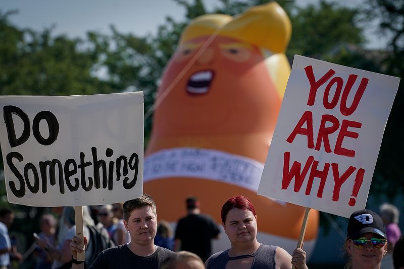 Protestors rally around a baby Trump balloon near Miami Valley Hospital in Dayton