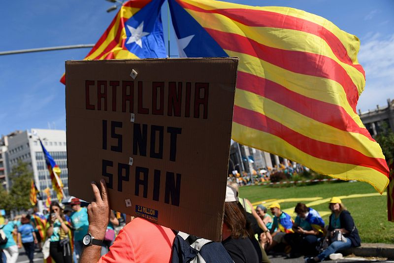 Un hombre sostiene una pancarta en la que se puede leer "Cataluña no es España". 