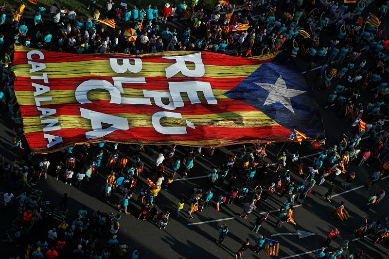 People hold a giant "Estelada" (Catalan separatist flag) at a rally during Catalonia's national day 'La Diada' in Barcelona