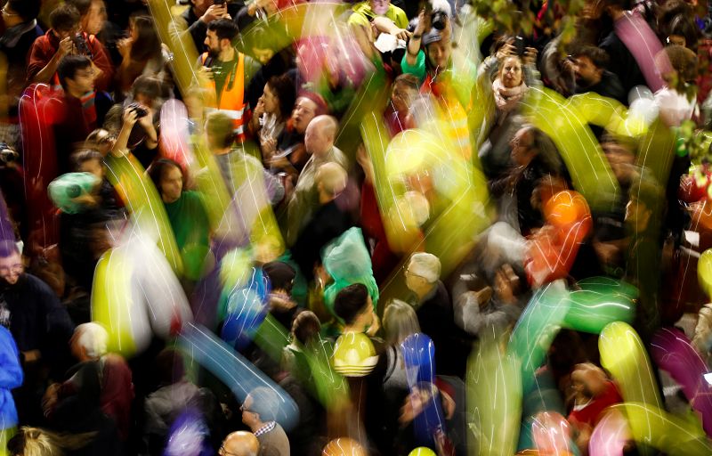 Pro-independence activists gather with balloons during a protest outside the Spanish government delegation offices in Barcelona