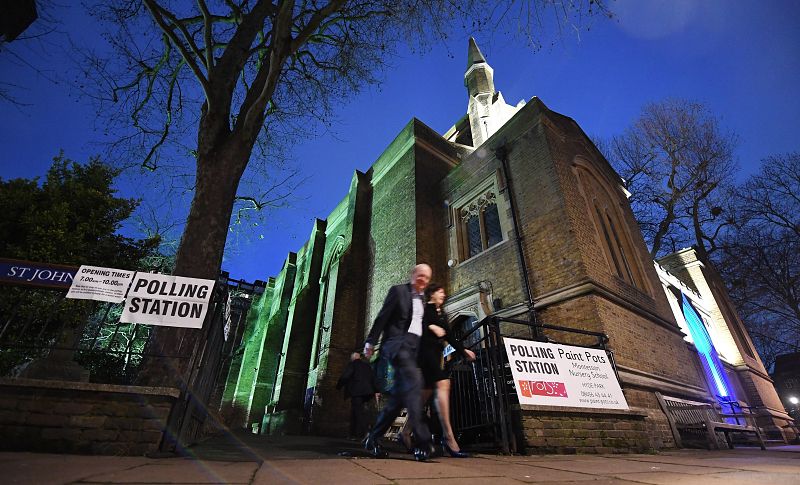 Una pareja sale de la Iglesia de St Johns después de votar en Londres.