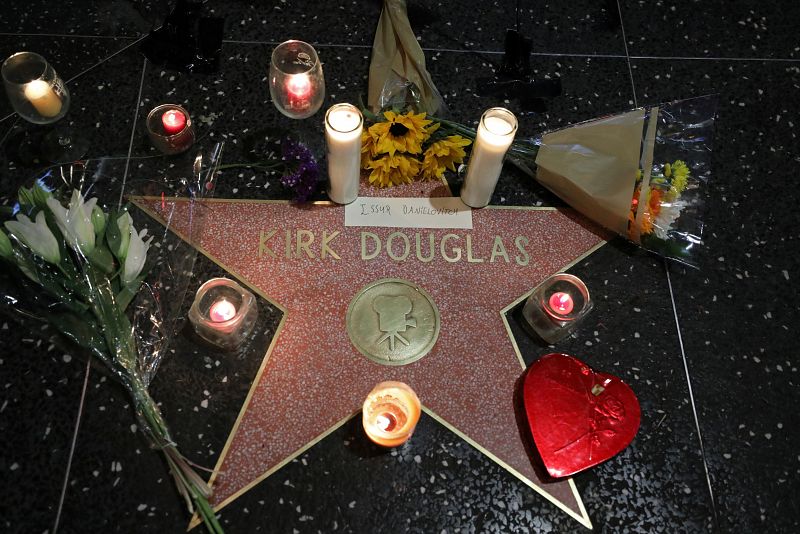 Flowers and candles surround the star of actor Kirk Douglas at Hollywood Boulevard and Vine