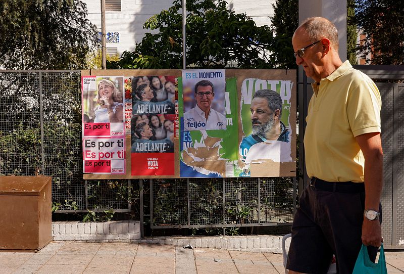 A man walks past electoral posters in Ronda