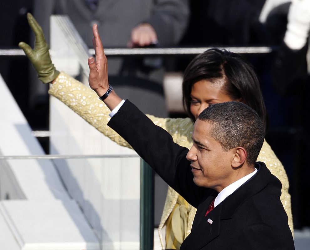 U.S. President Barack Obama waves with his wife Michelle at his side after being sworn-in as the 44th President of the United States in Washington