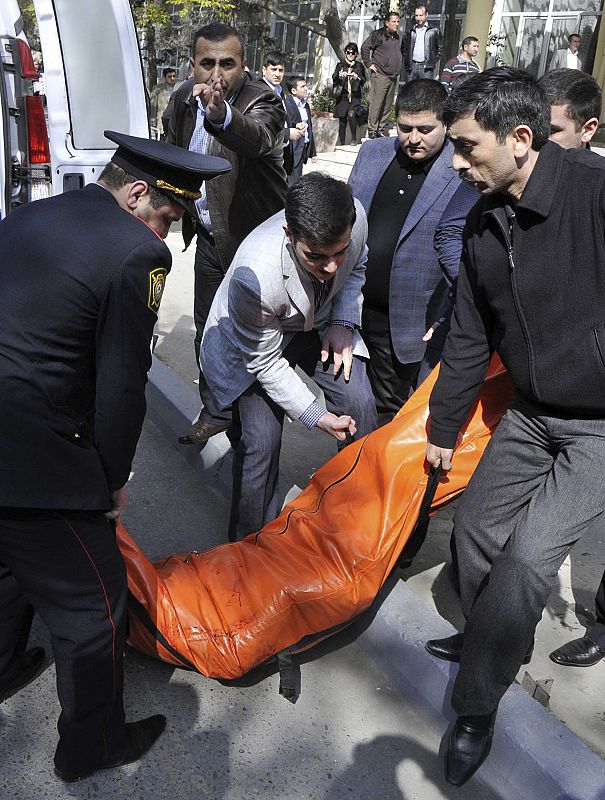 The body of a victim of a shooting at a university is carried to a van in Baku