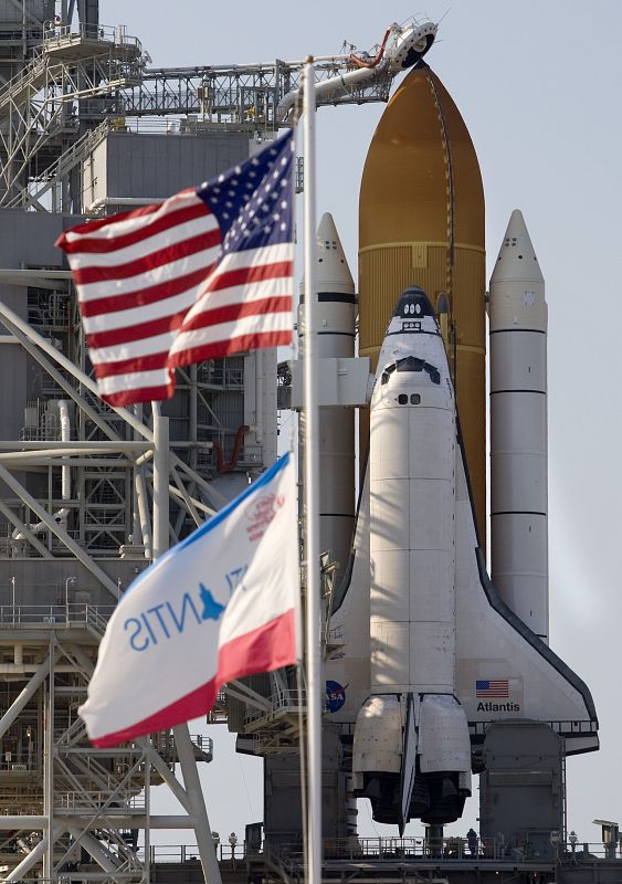 The space shuttle Atlantis is revealed by the rotating service structure as it sits on launch pad 39A at Kennedy Space Center in Cape Canaveral, Florida