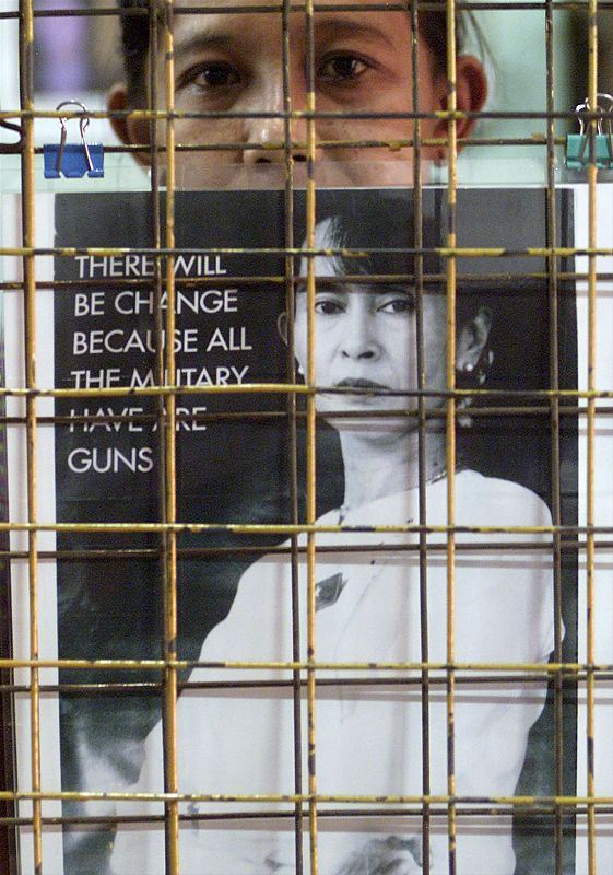 A WOMAN FROM MYANMAR SELLS PHOTOGRAPHS OF AUNG SAN SUU KYI IN YANGON.