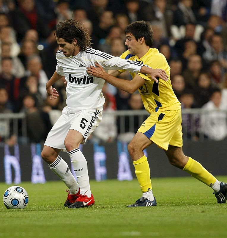 El centrocampita argentino del Real Madrid Fernando Gago protege el balón ante Sergio Mora, del Alcorcón.