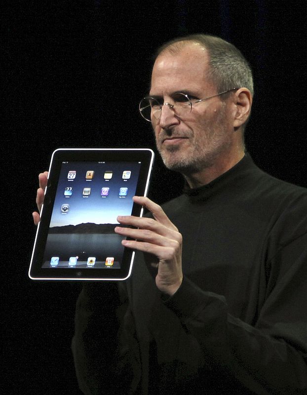 Apple CEO Steve Jobs holds the new " iPad" during the launch of Apple's new tablet computing device in San Francisco