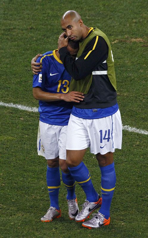 Brazil's Luisao consoles team mate Alves at the end of their 2010 World Cup quarter-final soccer match against Netherlands in Port Elizabeth