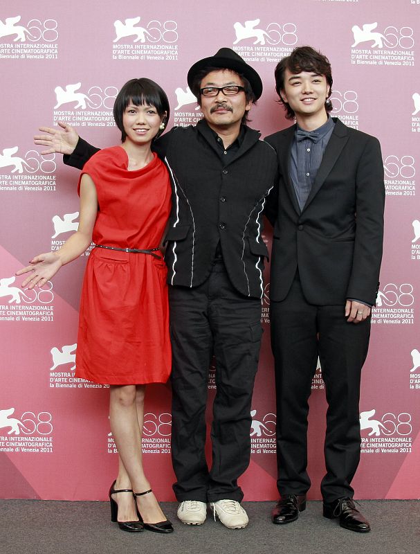 Director  Sono gestures as he poses with cast members Sometani and Nikaidou during a photocall for their film Himizu at the 68th Venice Film Festival