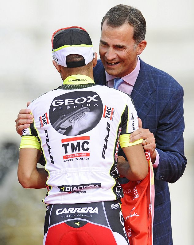 Geox TMC rider Juan Jose Cobo of Spain is congratulated by Spanish Crown Prince Felipe on the podium after winning the Tour of Spain "La Vuelta" cycling race