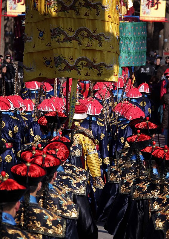 Performers march as they take part in an ancient Qing Dynasty ceremony during the opening of the temple fair at Ditan Park in Beijing