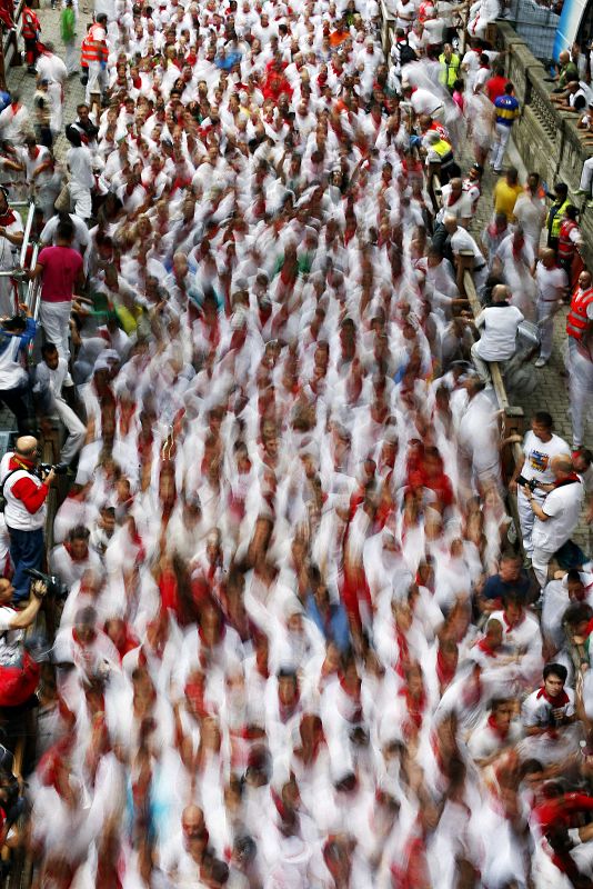 Runners sprint towards the entrance to the bullring during the seventh running of the bulls of the San Fermin festival in Pamplona