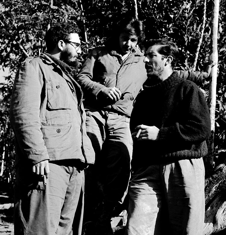 Fidel y Raúl Castro charlan con Enrique Meneses en Sierra Maestra.