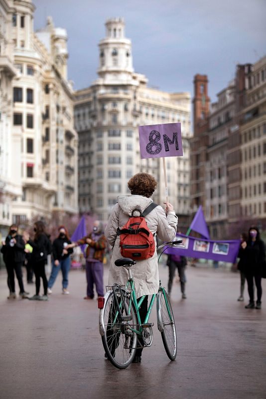 Una mujer sostiene un cartel del 8M en el centro de Valencia