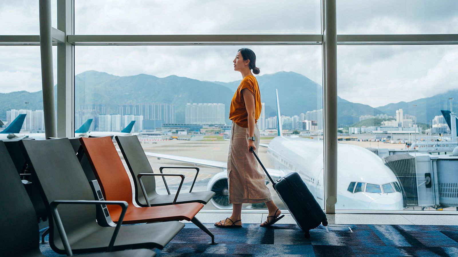 Imagen de archivo de una persona caminando hacia su puerta de embarque en un aeropuerto