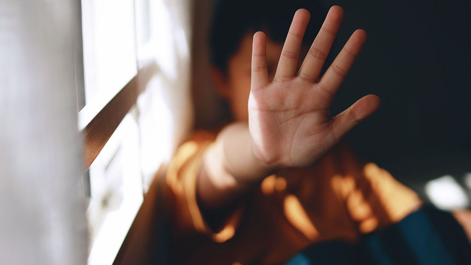 Un niño levanta la mano en un gesto contra la violencia