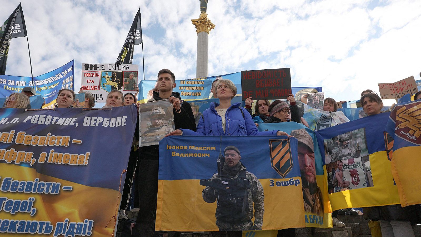 Familiares de soldados ucranianos desaparecidos sostienen pancartas y sus retratos durante una manifestación en apoyo de sus familiares