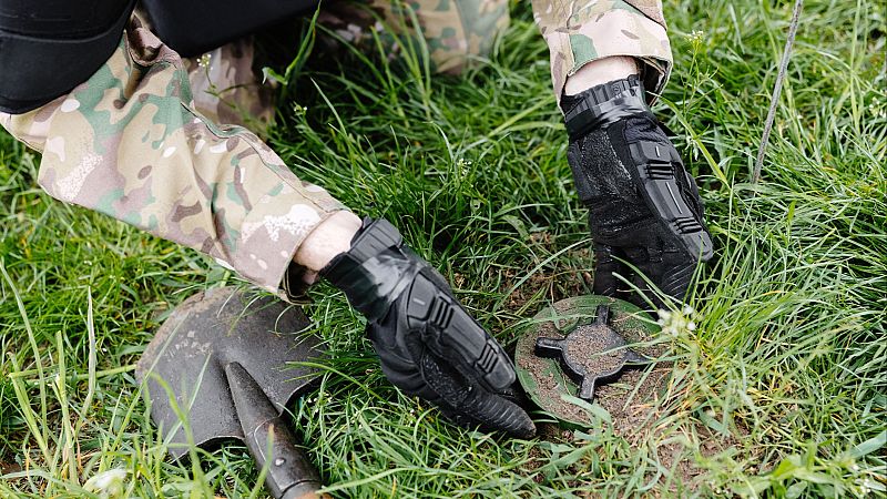 Un soldado desentierra una mina antipersona