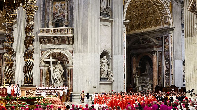 Cardenales en sotanas rojas reunidos en una imponente basílica para la elección papal.  Se aprecia la arquitectura y la solemnidad del evento.  Se celebra una Santa Misa.