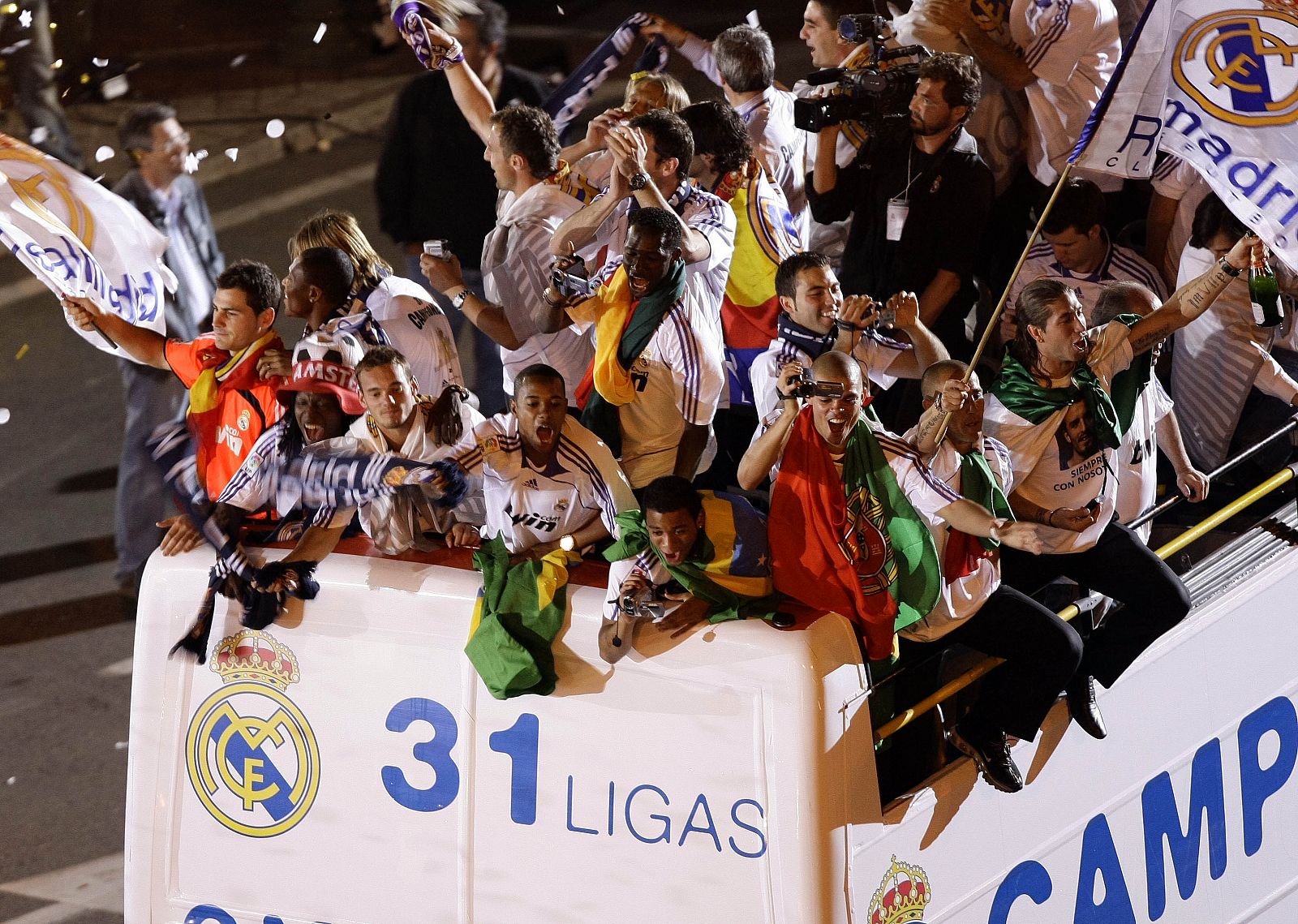 Real Madrid's players celebrate on board an open-top bus at Cibeles fountain in central Madrid