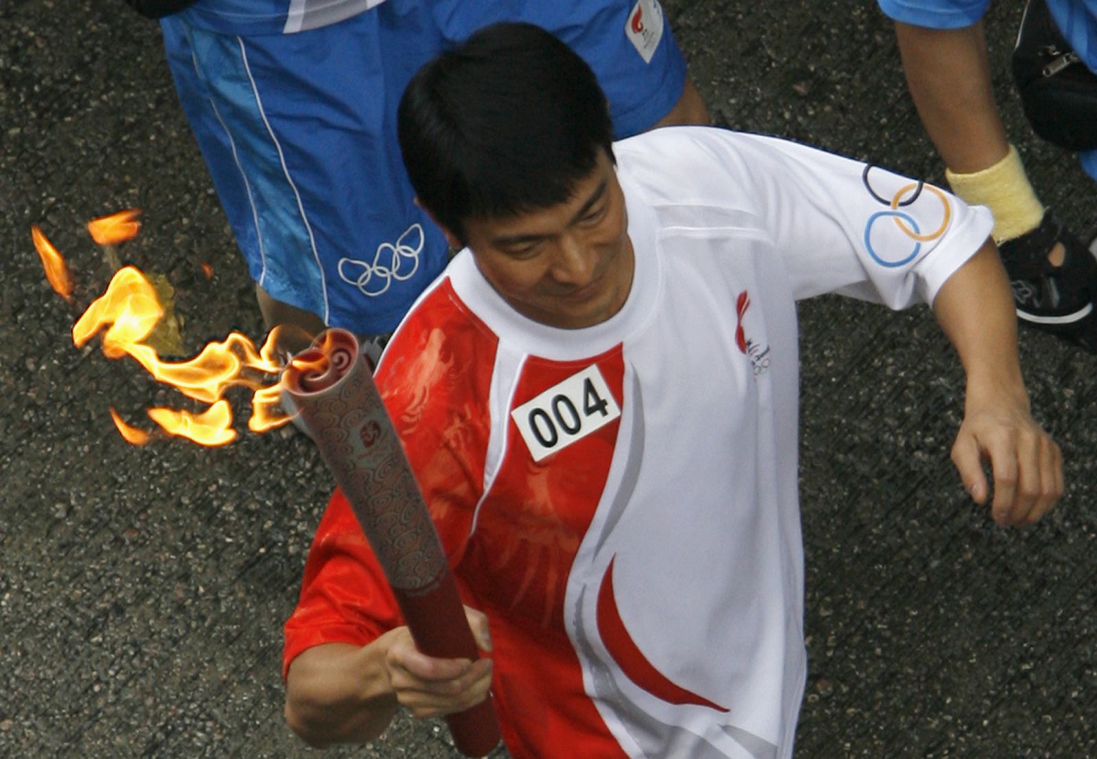 Hong Kong actor Andy Lau carries torch during Beijing Olympic torch relay in Hong Kong