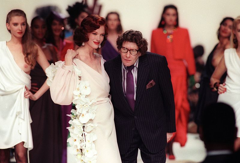El modisto francés con una modelo al final de un desfile celebrado en París en octubre de 1995.