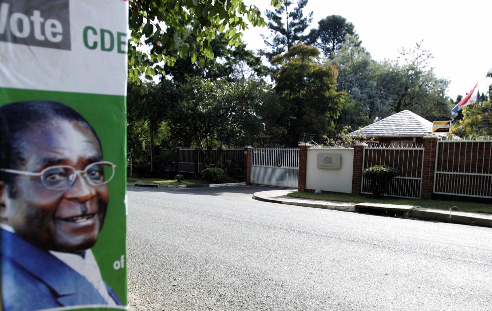 An election poster of President Mugabe is seen across the street from the Dutch embassy in Harare