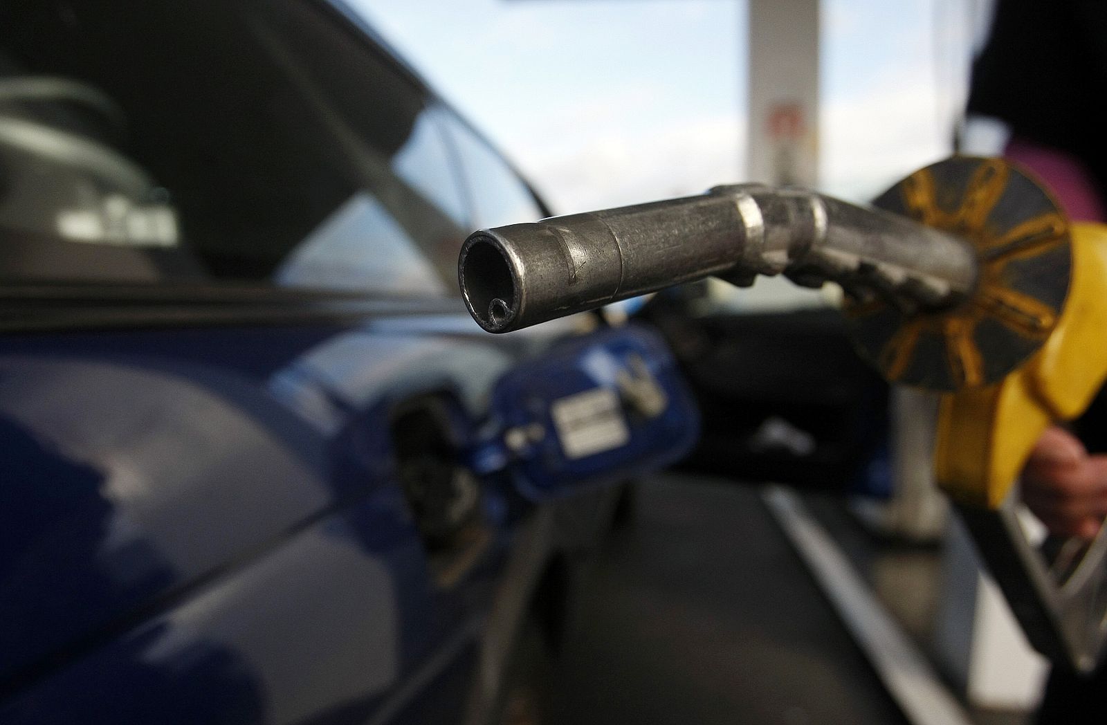 A motorist prepares to put fuel into her car at a petrol station in Melbourne