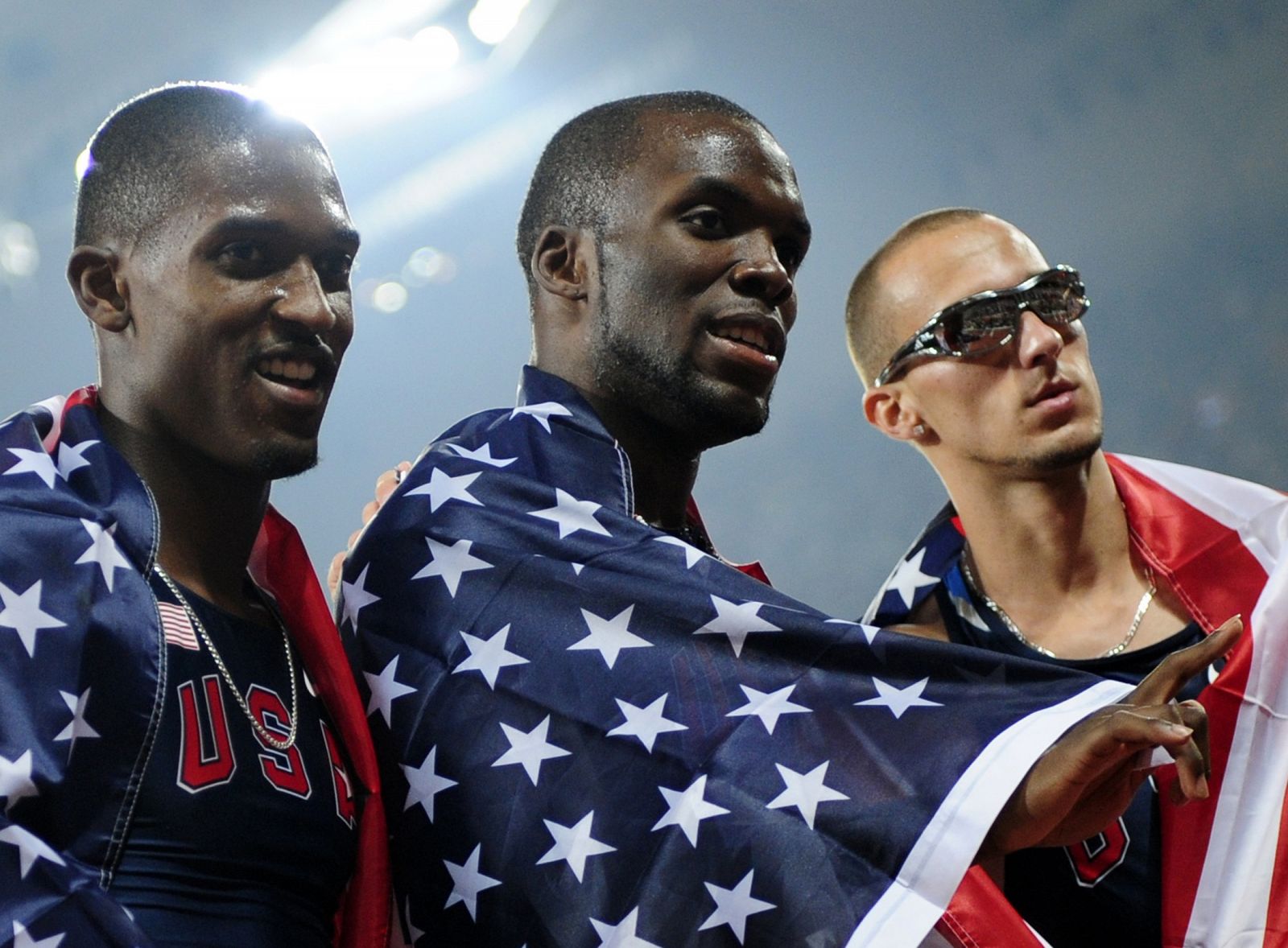 Neville of the U.S. and compatriots Merritt and Wariner celebrate after the men's 400m athletics final in the National Stadium at the Beijing 2008 Olympic Games