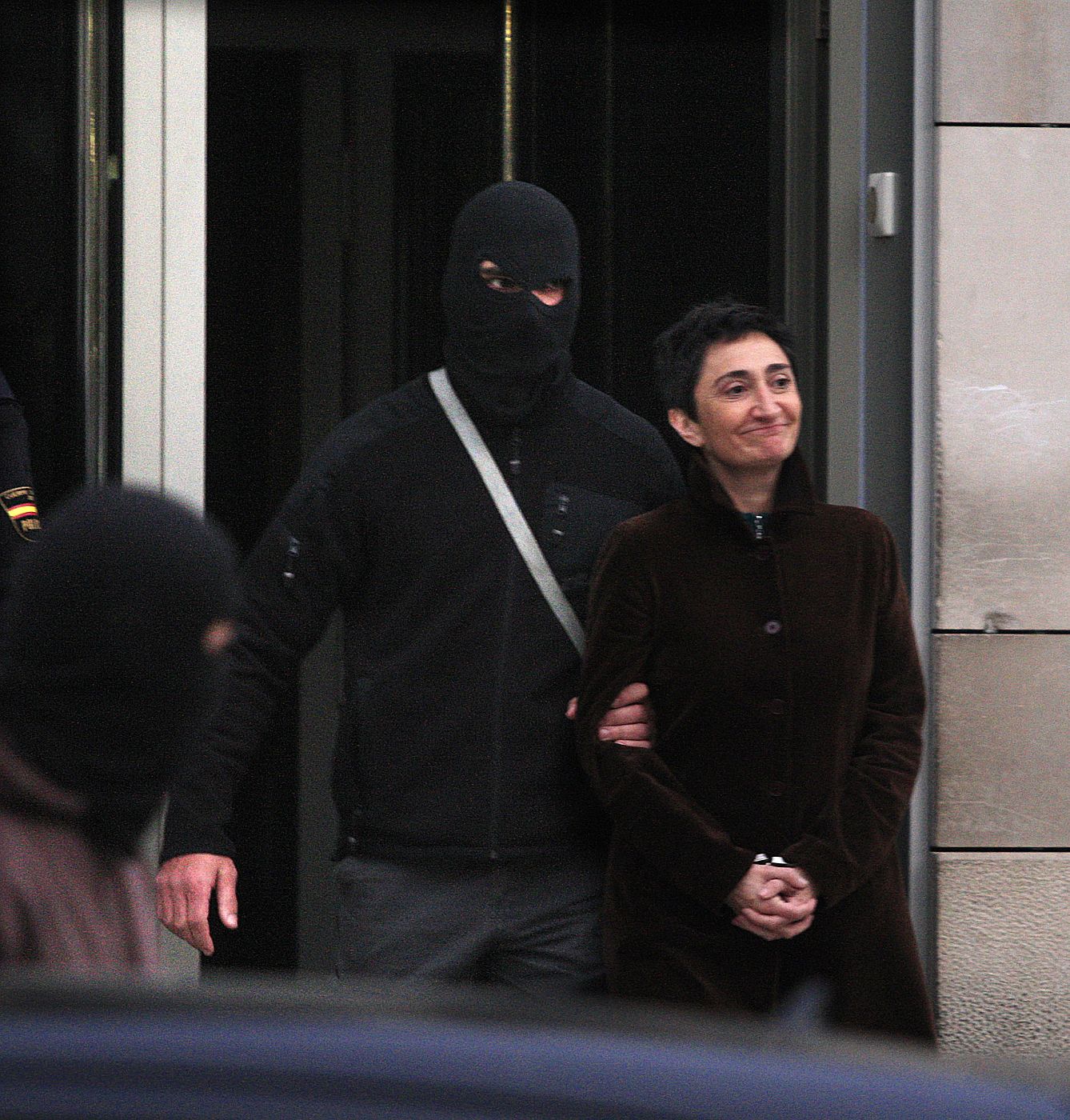 Elena Beloki is escorted by masked Spanish police in San Sebastian