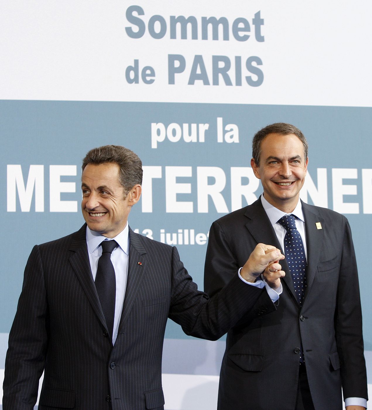 France's President Sarkozy greets Spain's PM Rodriguez Zapatero at EU-Mediterranean summit in Paris