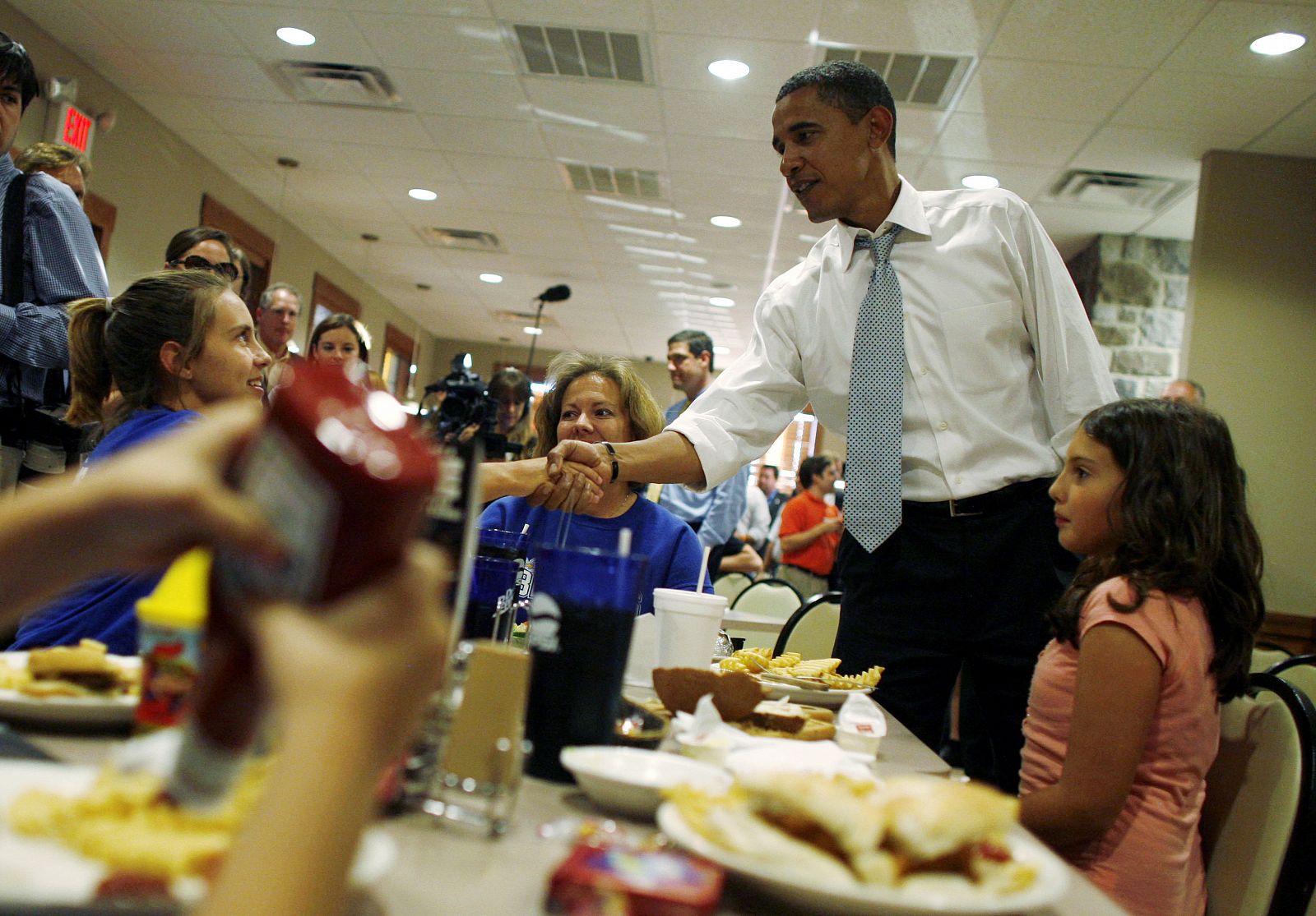 Obama saluda a los clientes de un restaurante en Ohio, estado industrial donde va a pasar esta semana preparando el último debate.