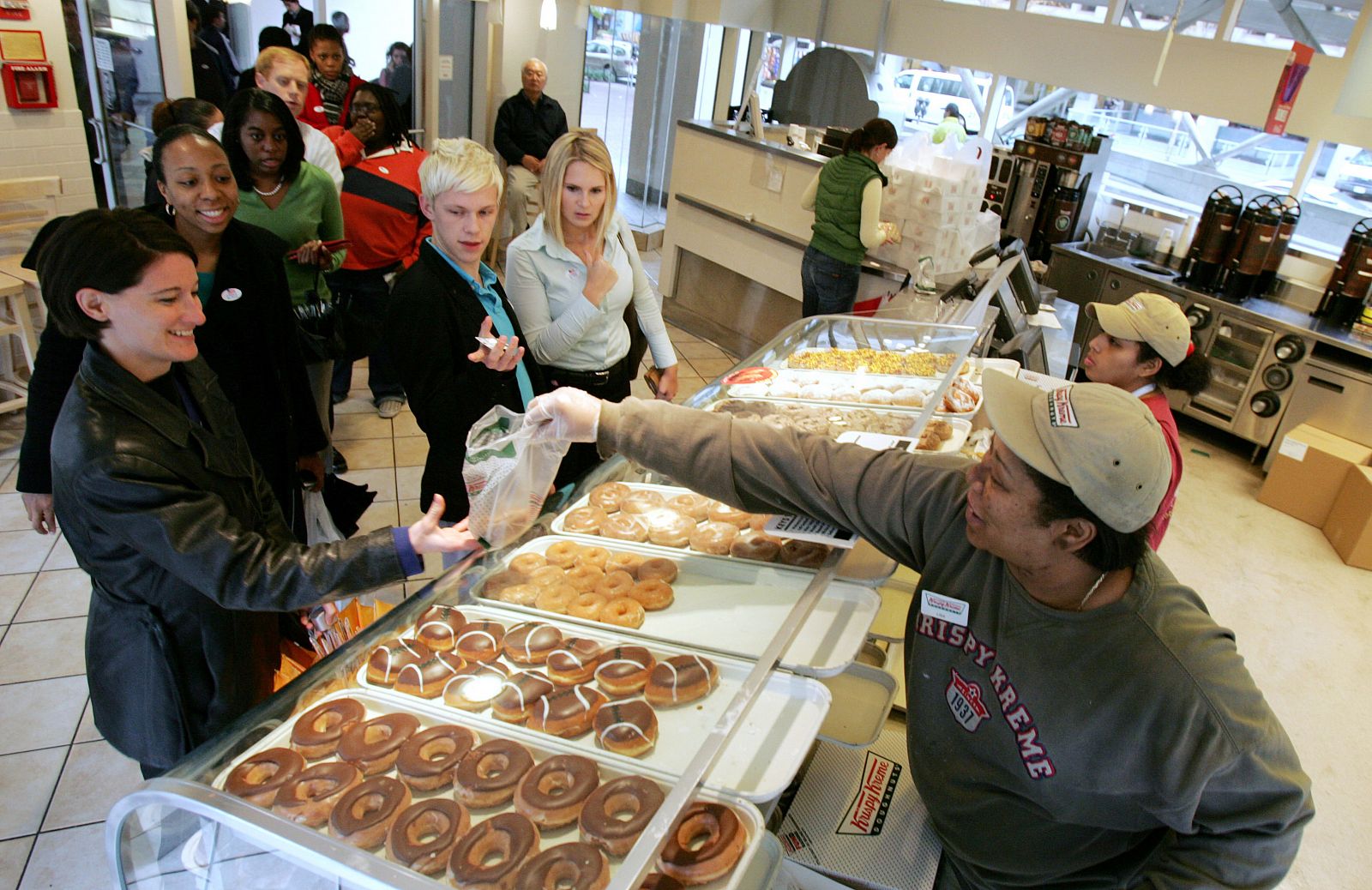 Customers wait inside a Krispy Kreme Doughnuts store for free doughnuts to anyone with an "I Voted" sticker on election day in Washington