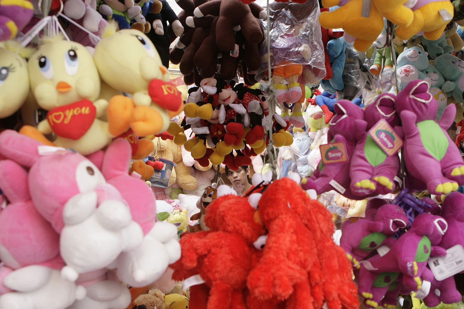 A man looks for Christmas gifts inside a toy stall along a street in Manila