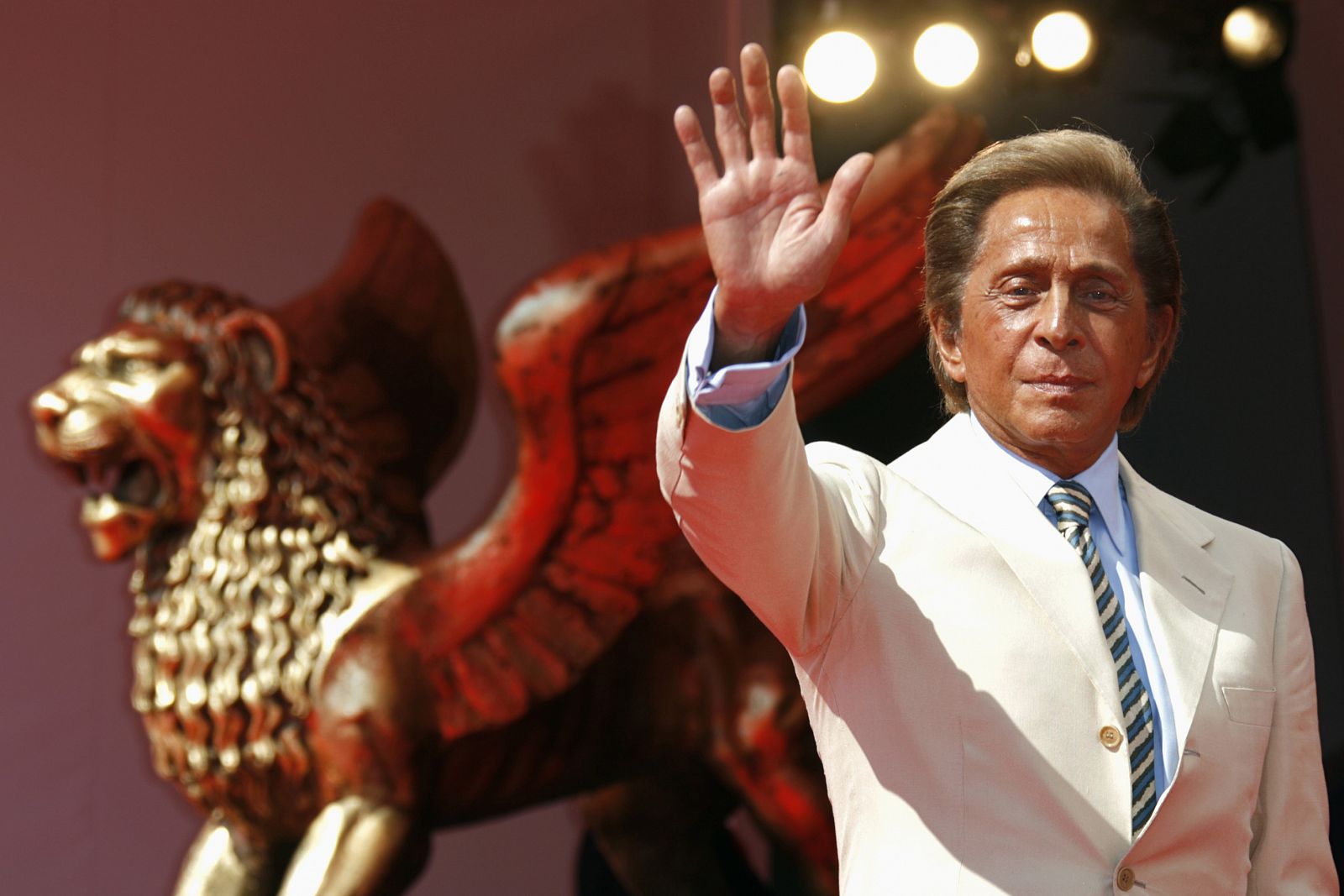 Italian fashion designer Valentino waves as he arrives for the premiere of the movie "Valentino:The Last Emperor" by U.S. director Matt Tyrnauer in Venice