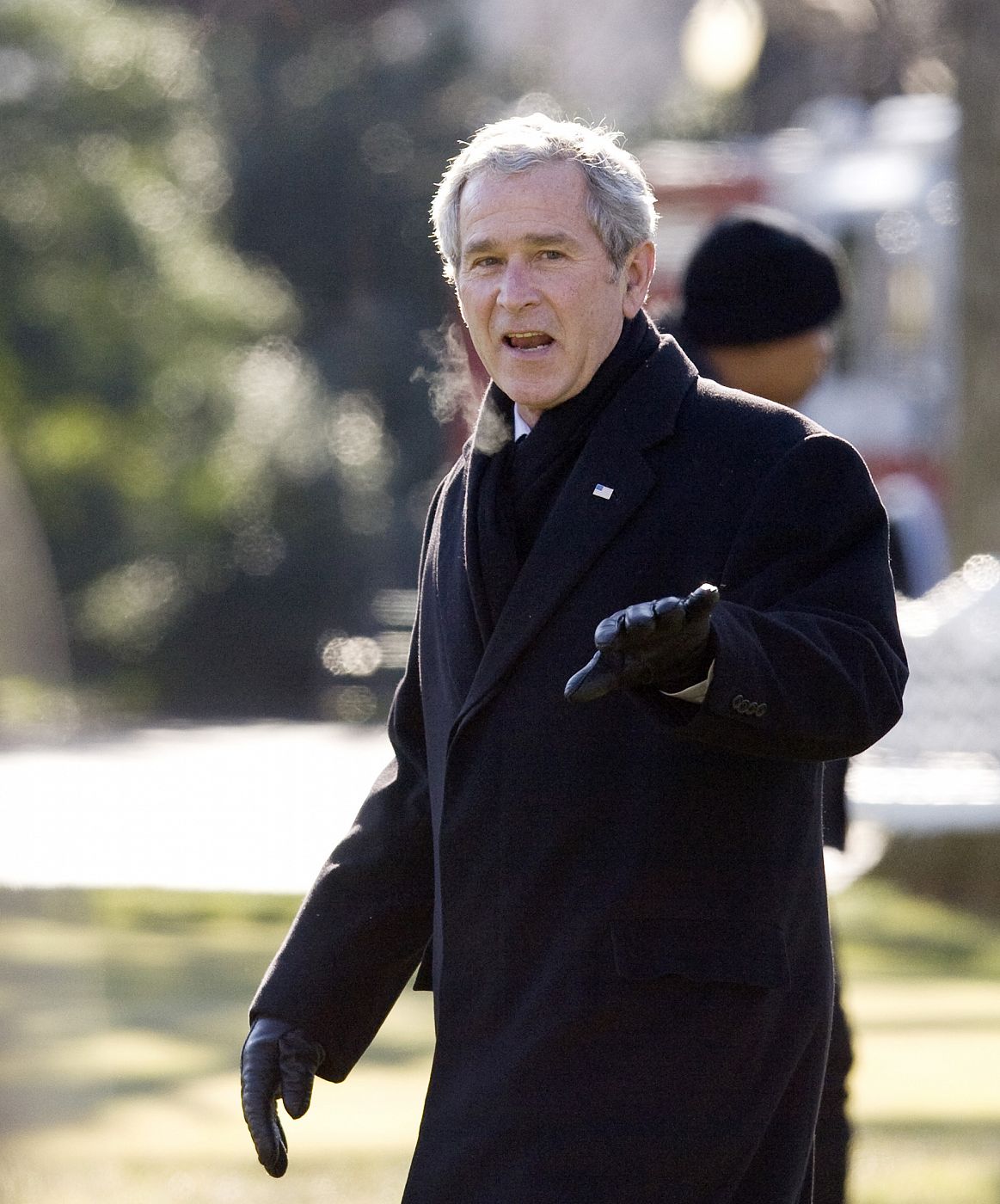 U.S. President Geore W. Bush waves before departing the White House in Washington