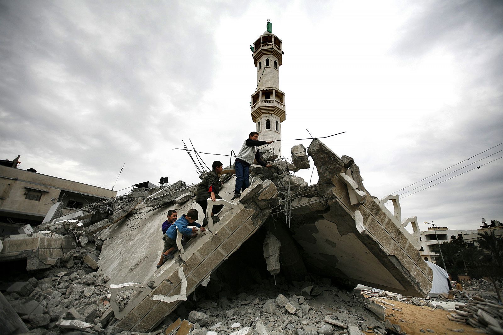 Chicos palestinos juegan en las ruinas de una mezquita destruida en Jabalya