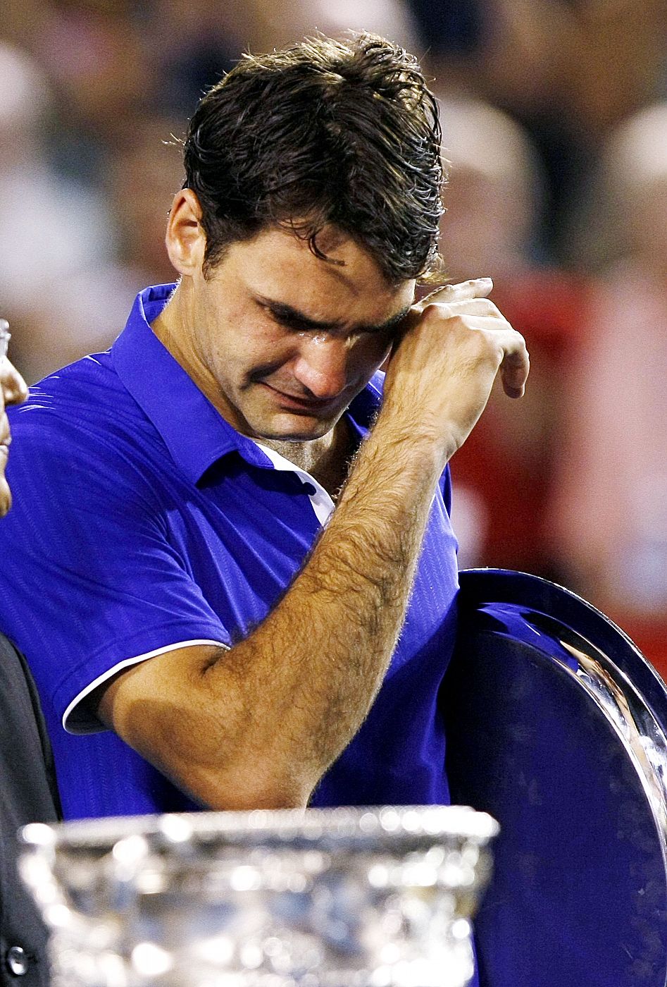 Switzerland's Federer cries after losing his men's singles final match against Spain's Nadal at the Australian Open