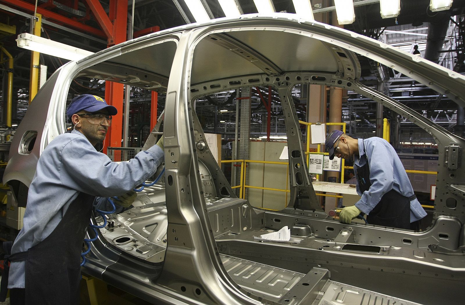 Workers assemble a car at the Renault automobile manufacturing plant in Curitiba