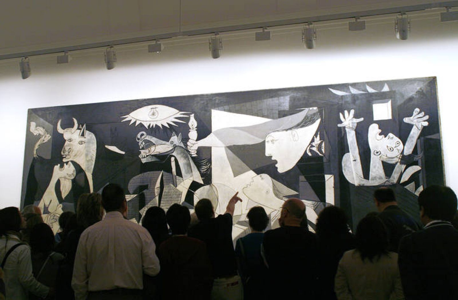 Visitors look at Spanish artist Picasso's "Guernica" in Madrid