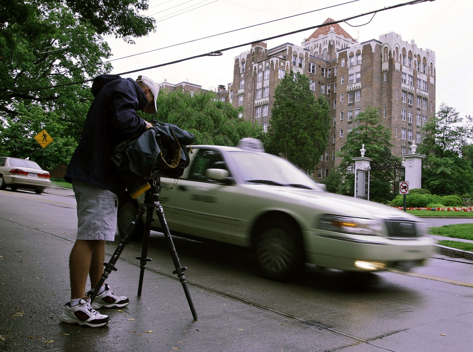 A news TV cameraman films outside the residence of accused spies Walter and Gwendolyn Myers in Washington