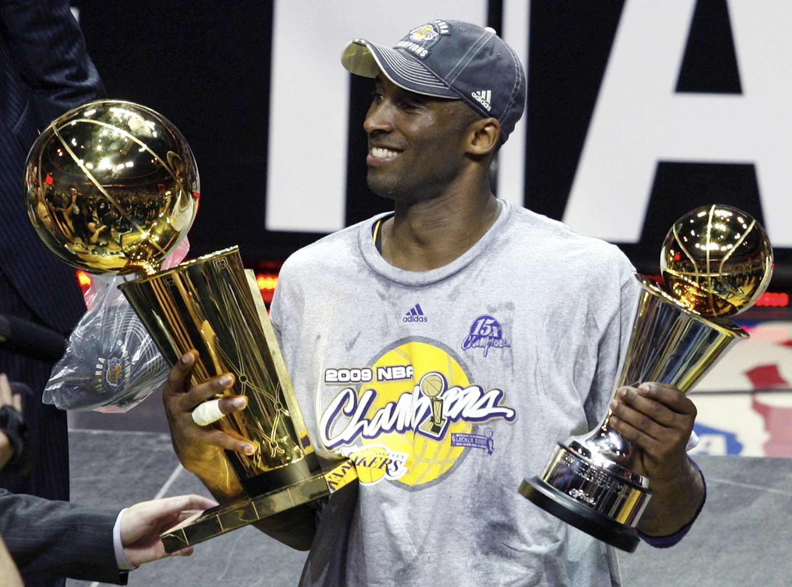 Los Angeles Lakers Kobe Bryant holds trophies after they defeated the Orlando Magic to win the NBA basketball championship in Orlando