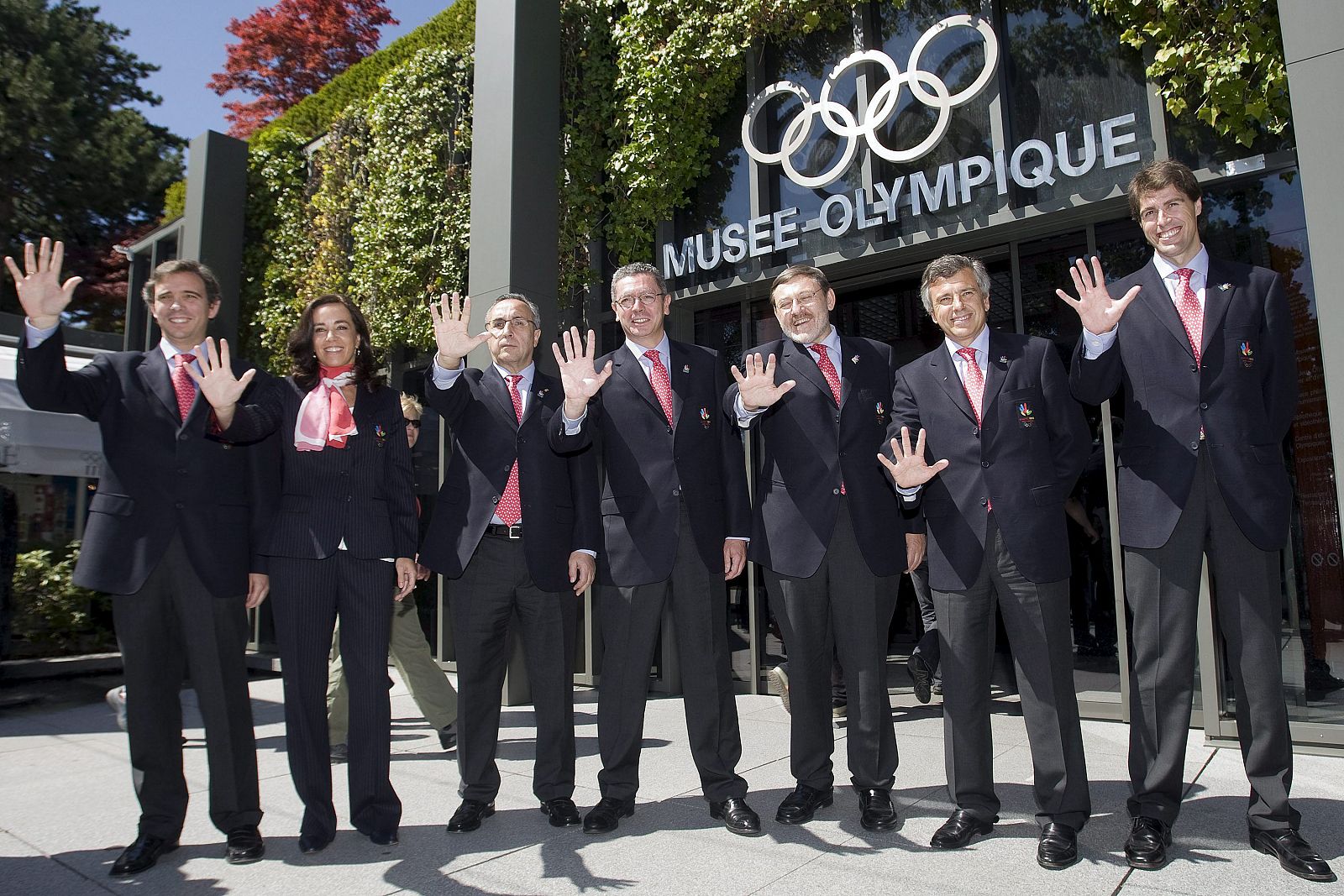 Los miembros de la delegación española posan haciendo el saludo de Madrid 2016.